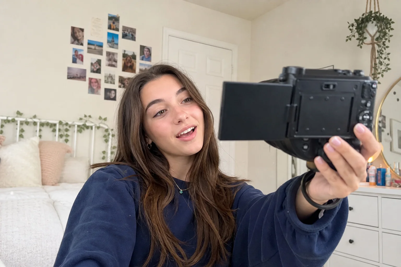 Teenager vlogging with Saneen digital camera flip screen in a bright room